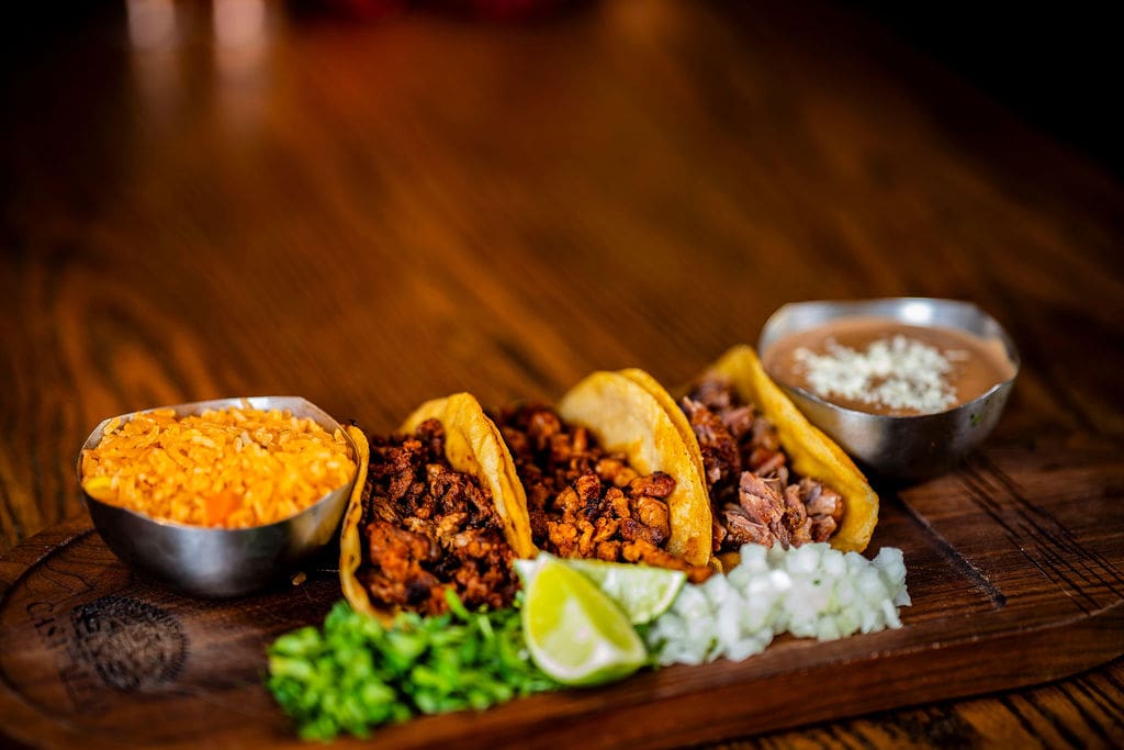 Tacos with sides of rice and beans