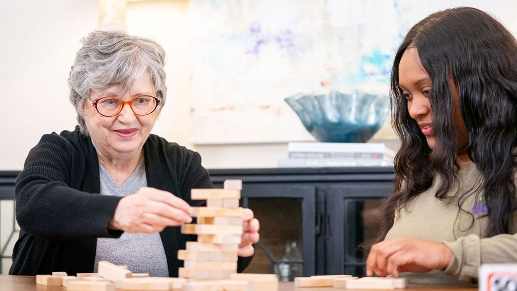 Two people playing a stacking game.
